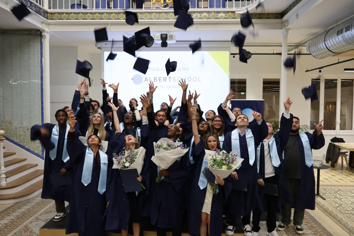 Albert School graduates throwing their caps at the graduation ceremony